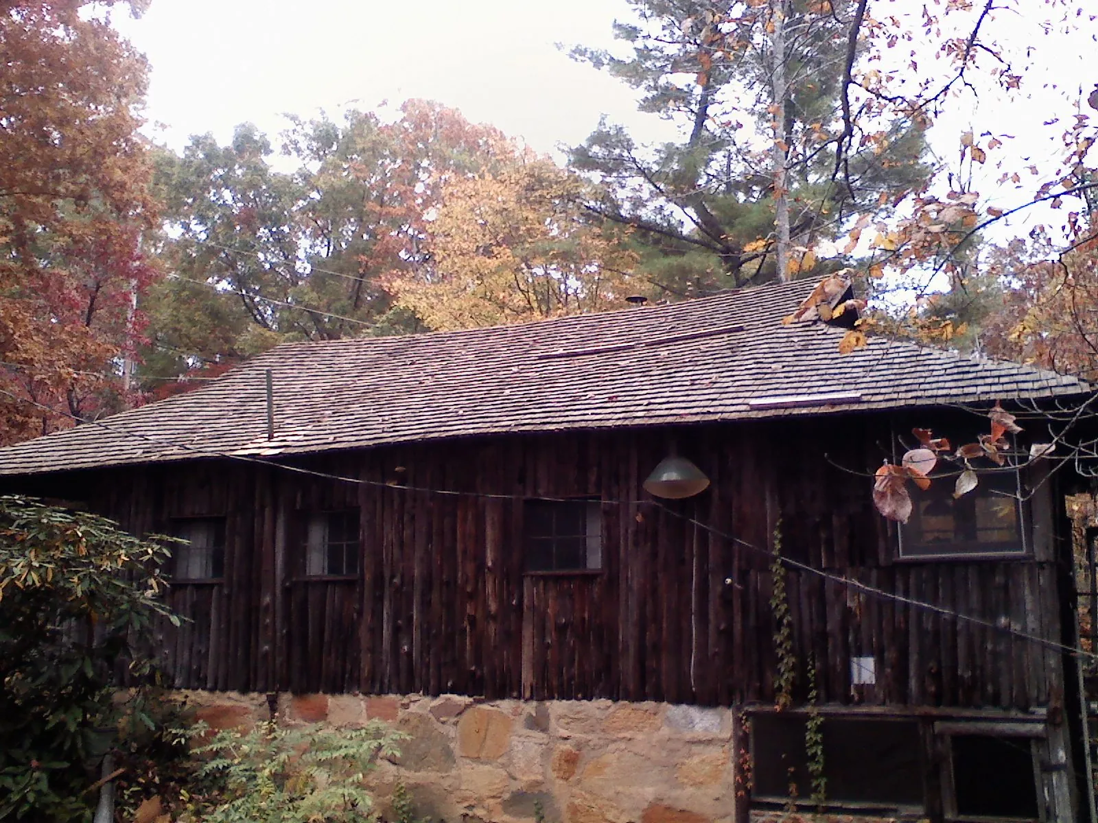 Weathered wood shake roof on a rustic board sided cabin in Morgantown
